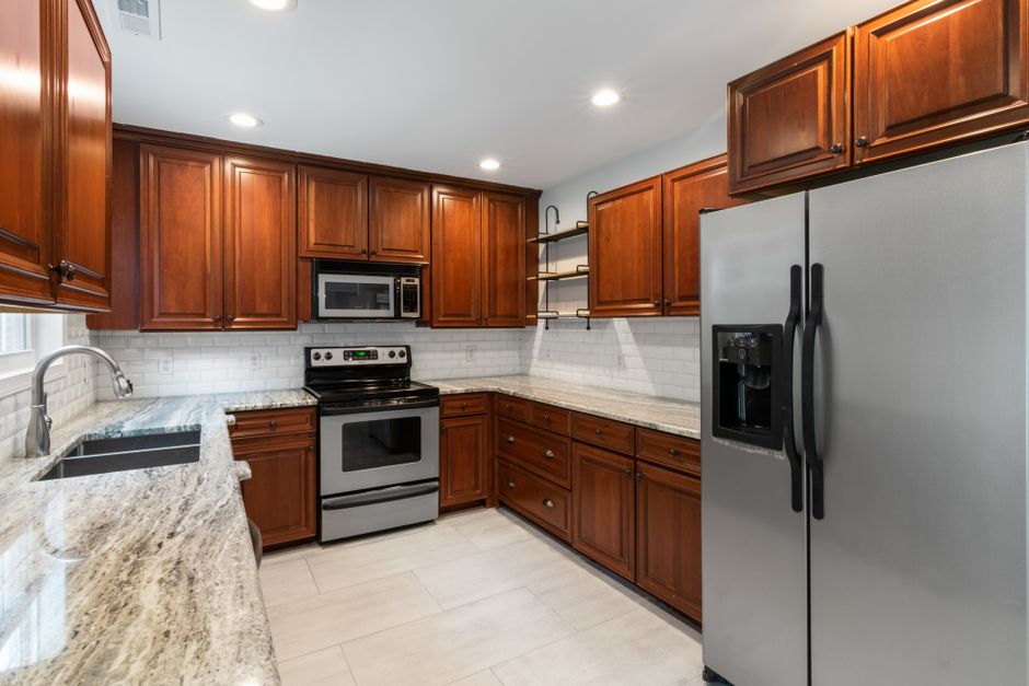 Elegant kitchen interior featuring wooden cabinetry and stainless steel appliances.