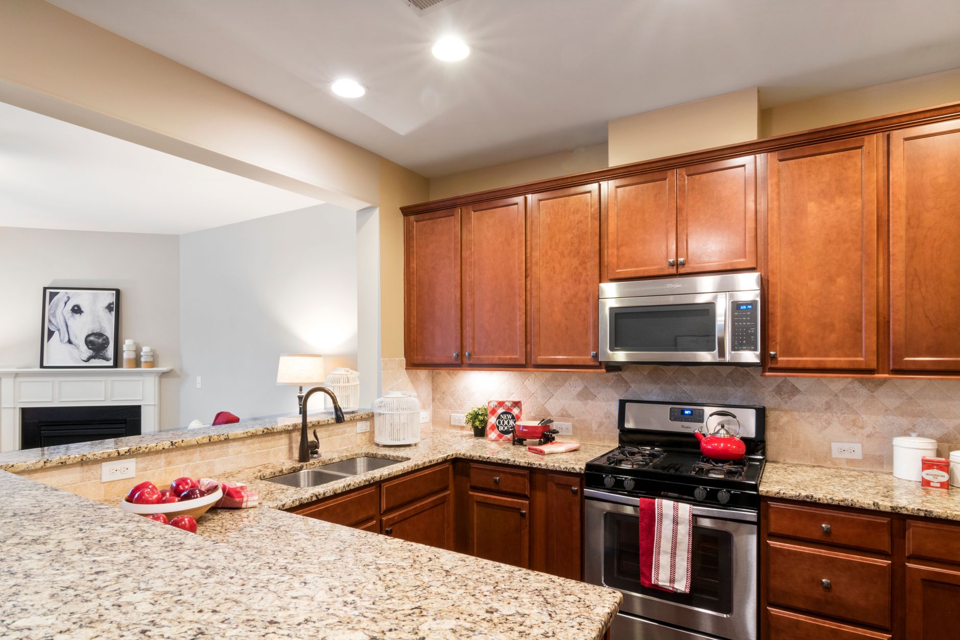 Stylish kitchen with granite countertops, wooden cabinets, and stainless steel appliances in Temecula, CA