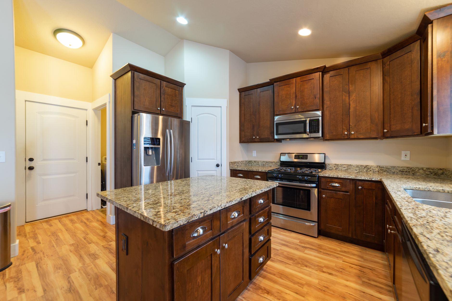 Spacious kitchen featuring wooden cabinets, granite countertops, and stainless steel appliances in Temecula, CA
